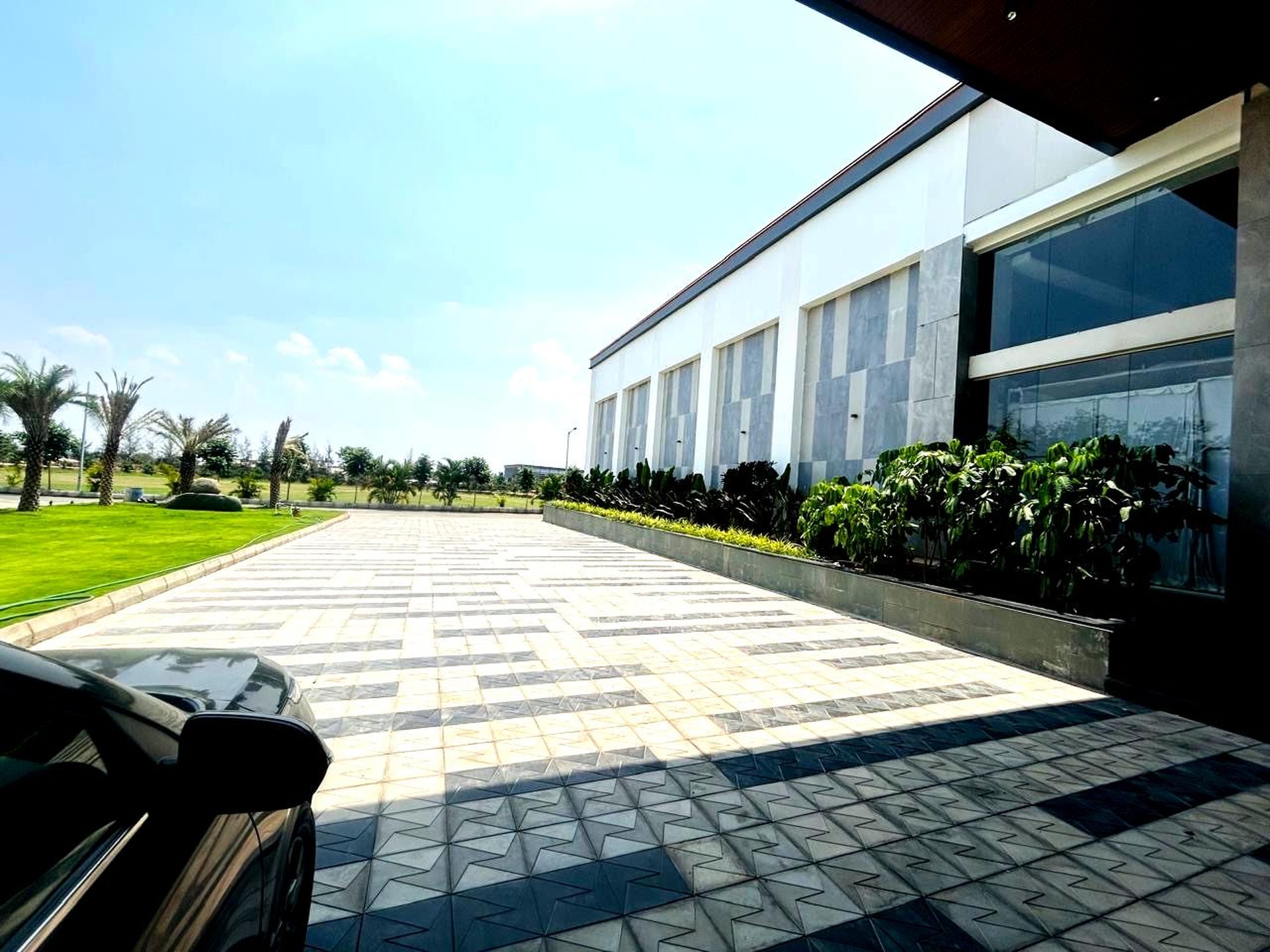 Daytime view of the palm-lined exterior facade